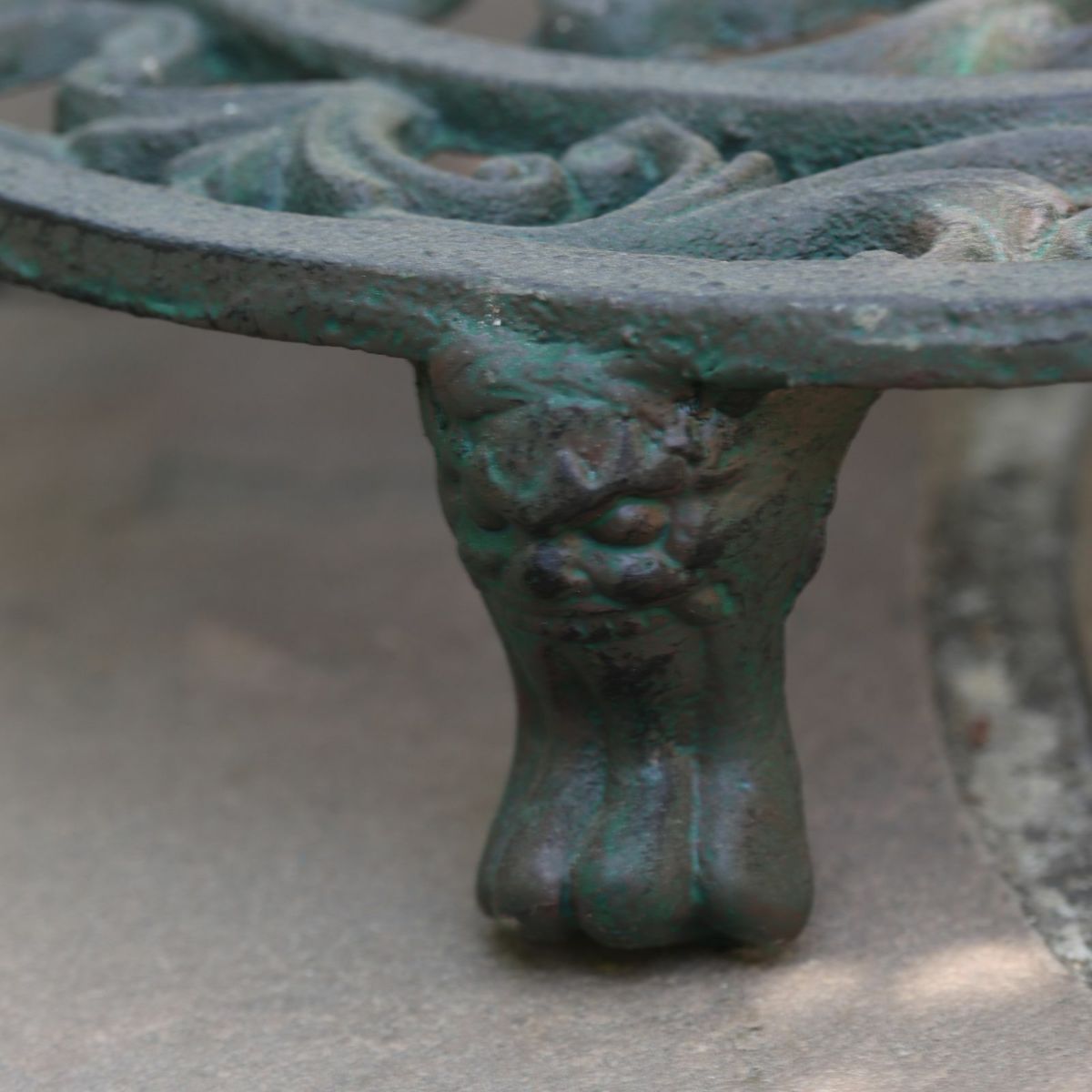 鬼のようなデザインが施された花スタンドの脚が映った写真